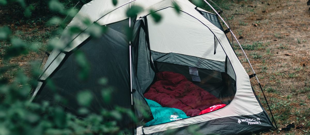 Cozy camping tent set up in an Ontario forest for an outdoor adventure.