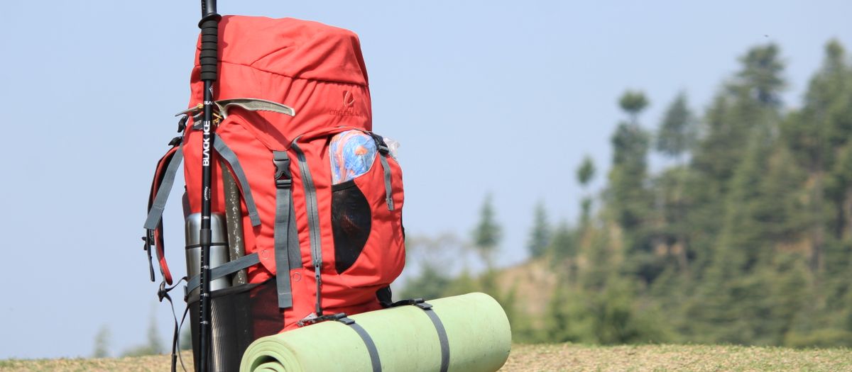 A backpacker hiking toward a high camp with a light pack.